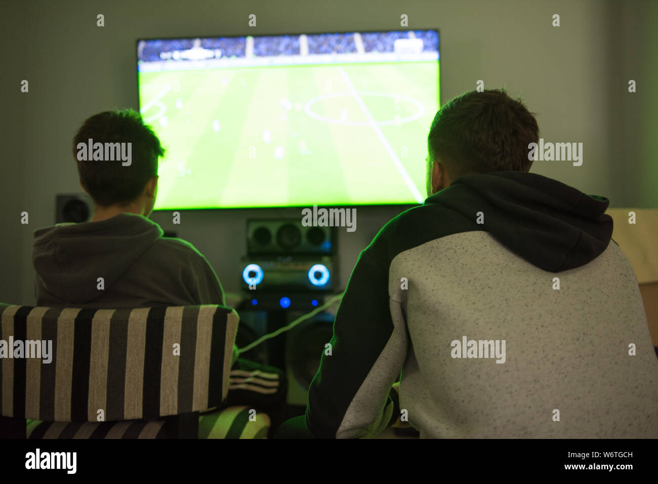 Two teenagers playing video game Stock Photo