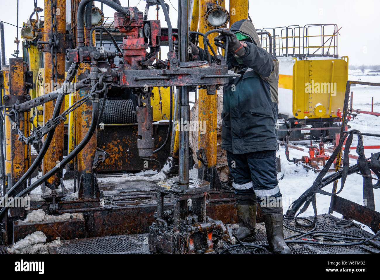Workover rig working on a previously drilled well trying to restore ...