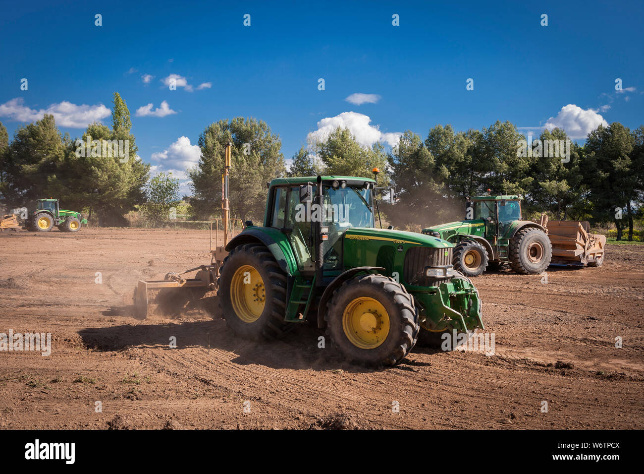 Tractors leveling in the field Stock Photo Alamy