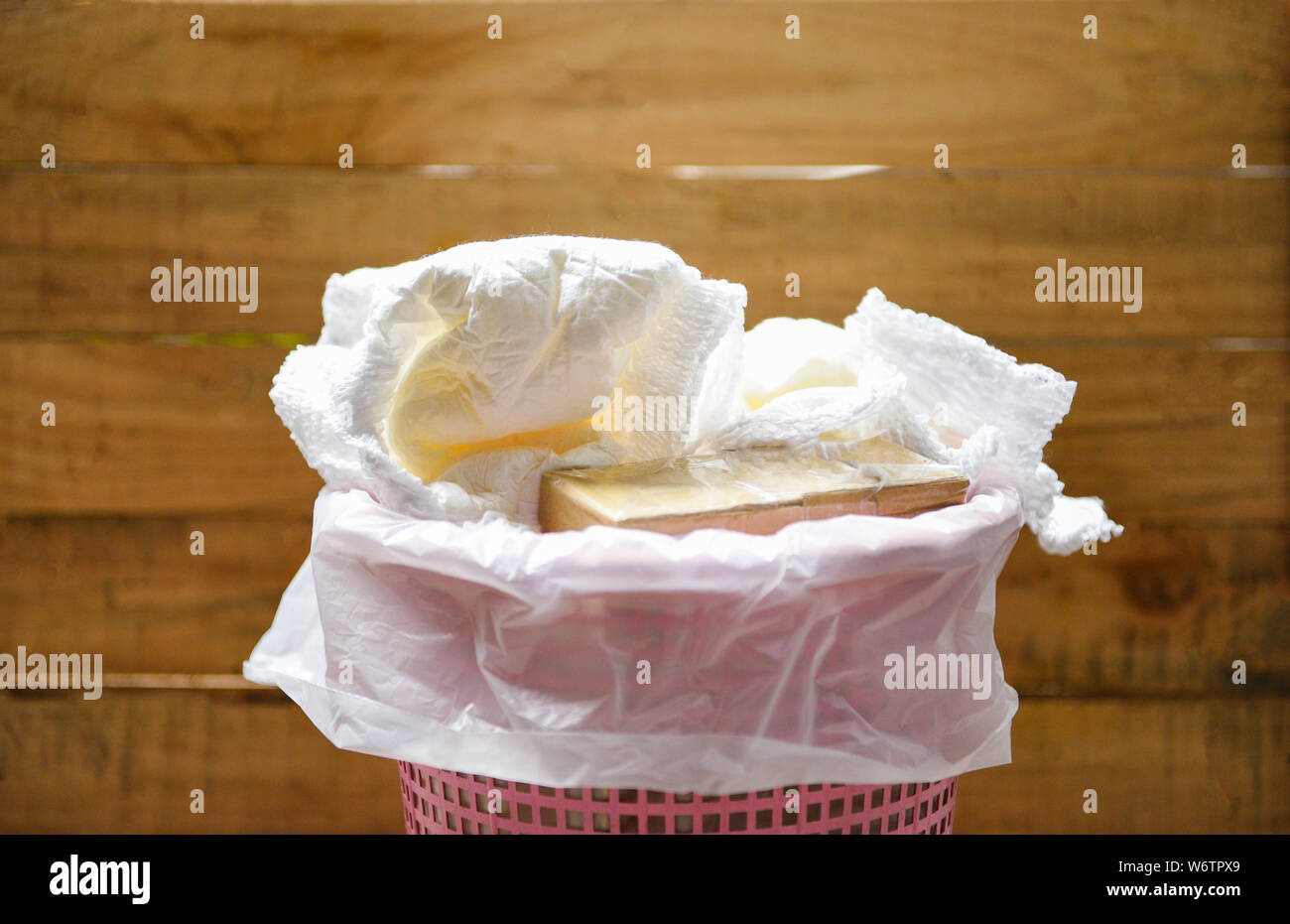 Diapers waste / dirty diapers in a garbage pail Disposing of used baby