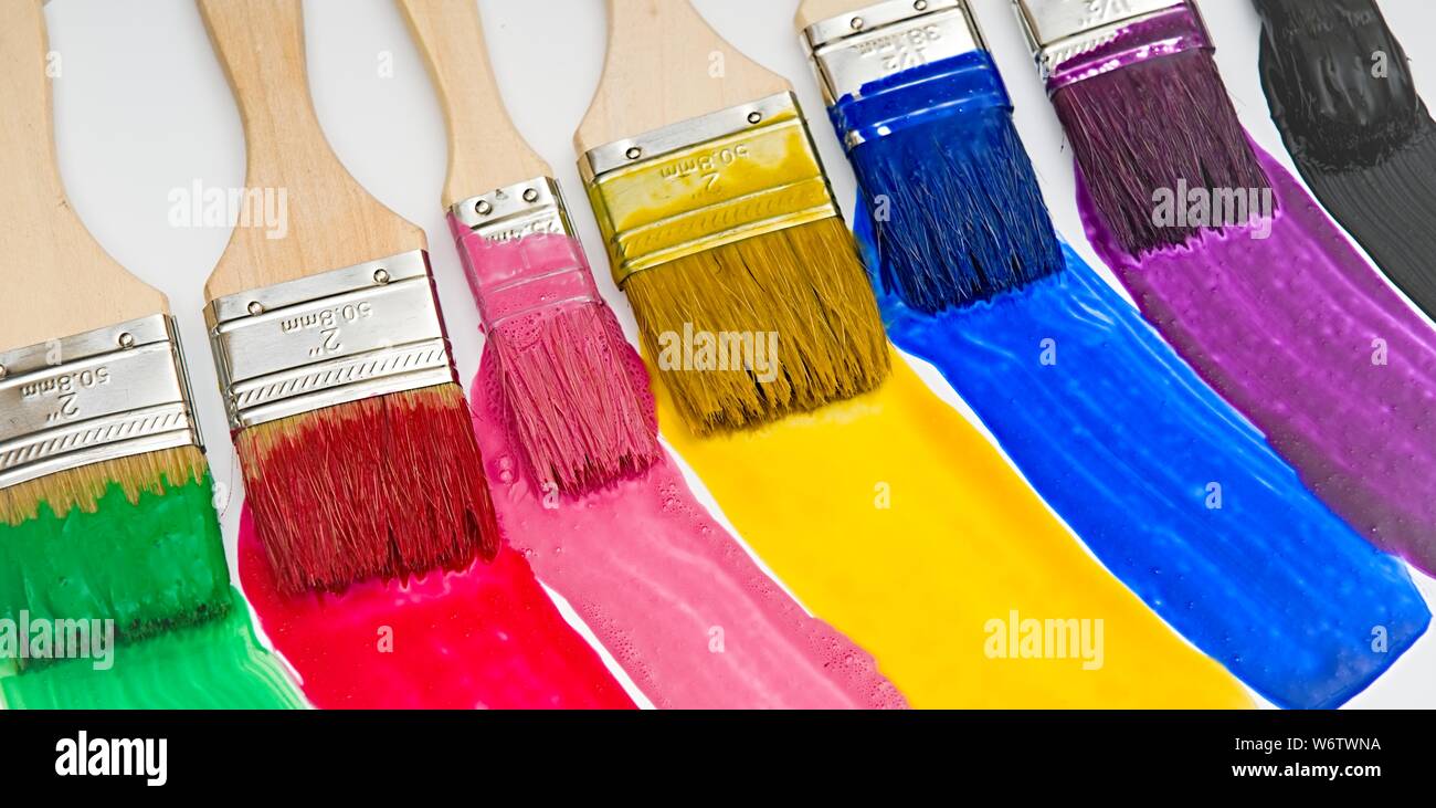 Paintbrushes dripping paint of various colors Stock Photo Alamy