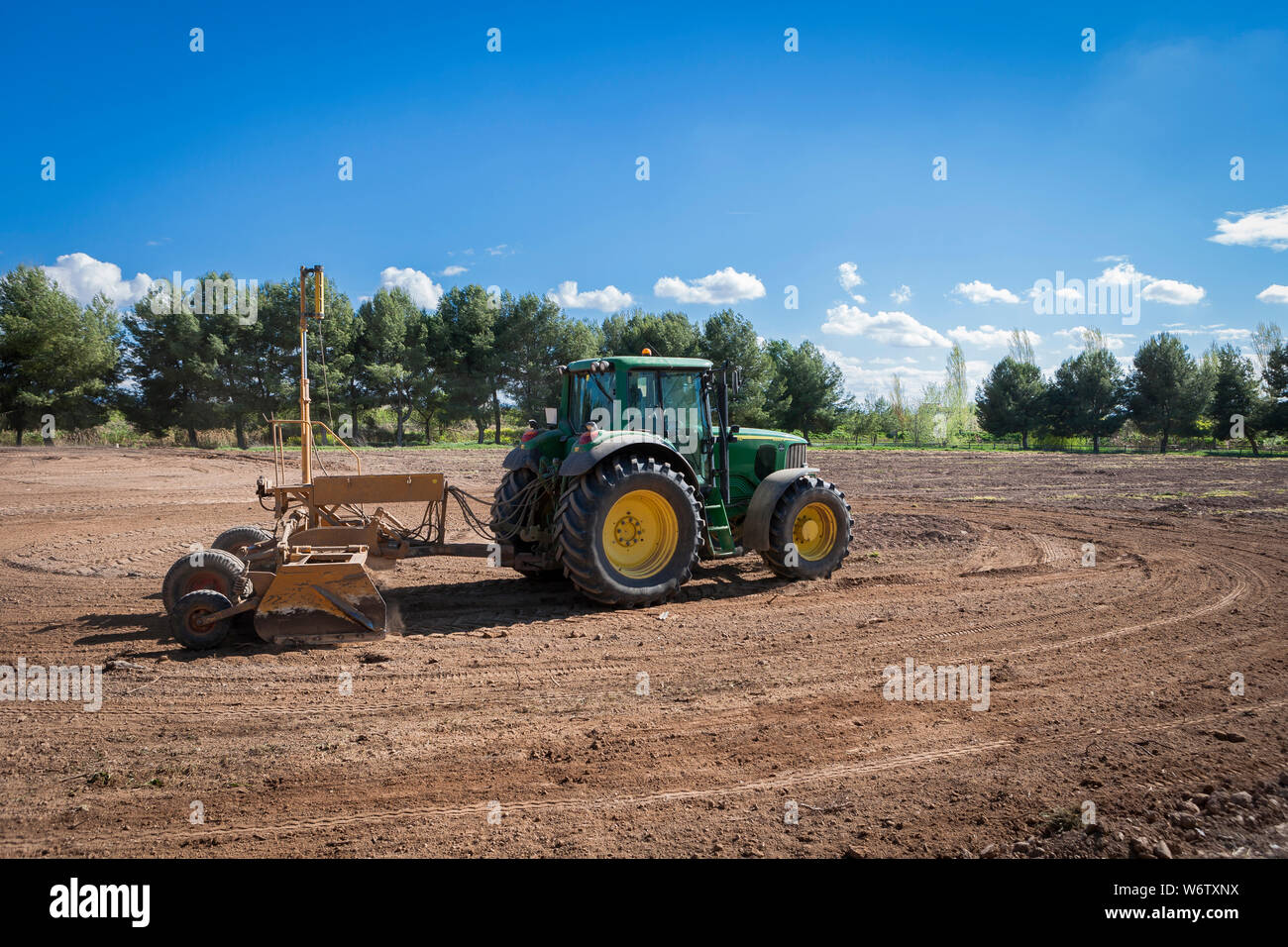 Tractors leveling in the field Stock Photo Alamy