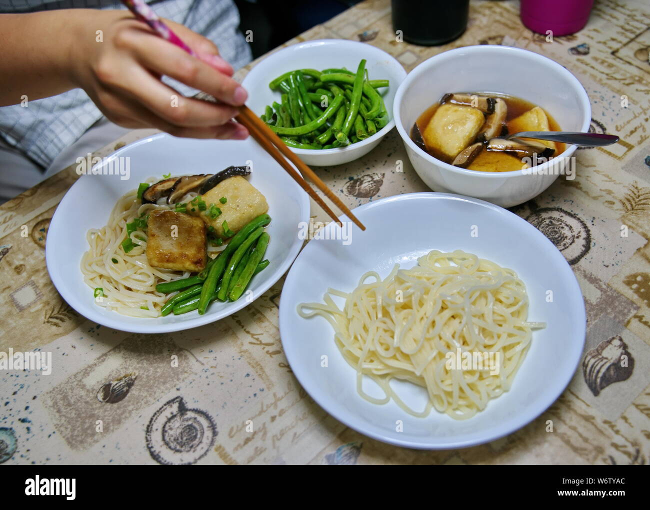 Japanese style udon noodles dipping soup with green beans, mushrooms