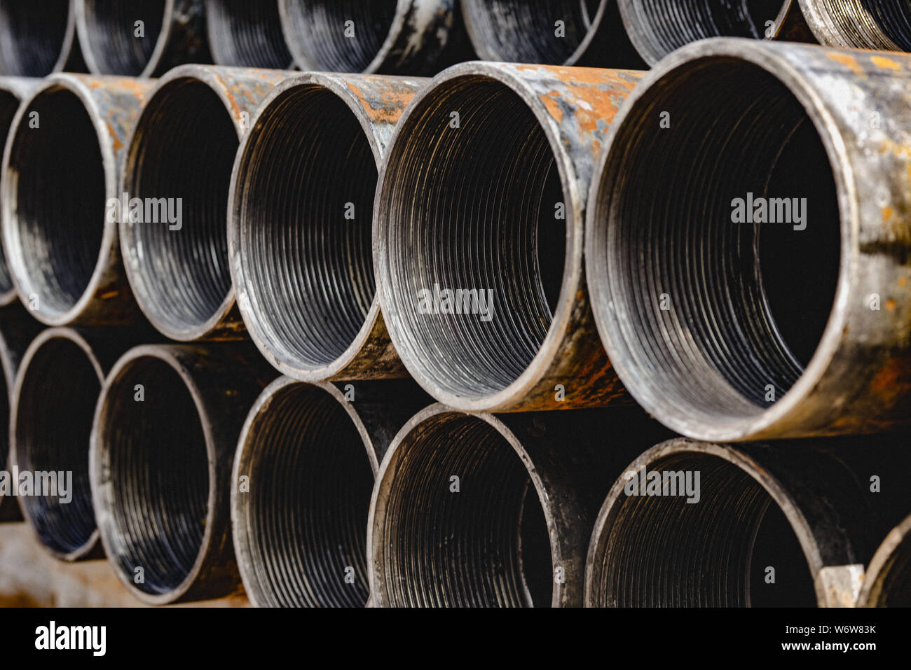Steel Pipes bunch on the rack in warehouse. Iron pipes at shelf in