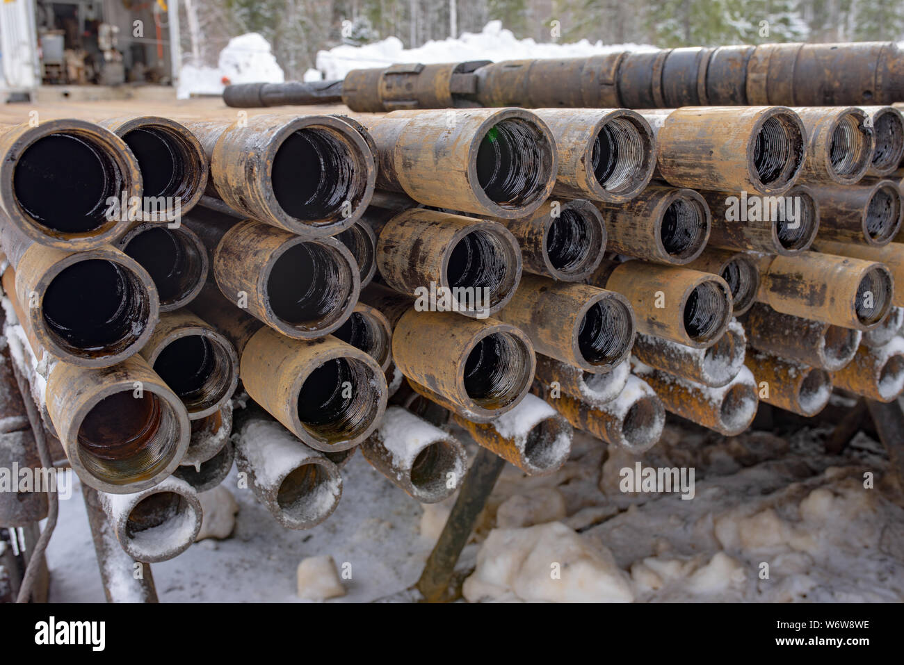 Offshore Industry oil and gas production petroleum pipeline. Downhole drilling rig. Laying the pipe on the deck. View of the shell of drill pipes laid Stock Photo