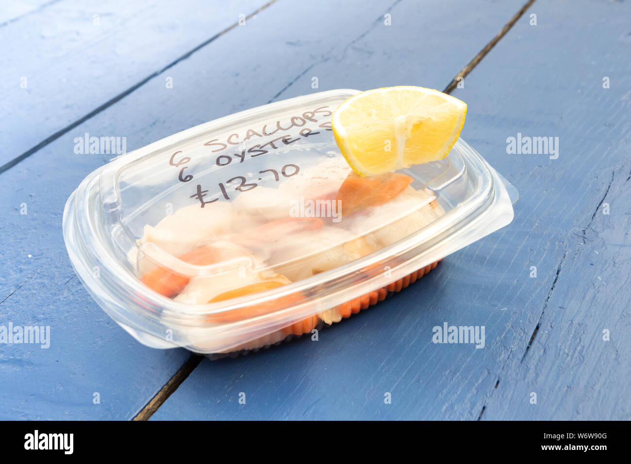 fresh raw scallops in a plastic box for take away Stock Photo