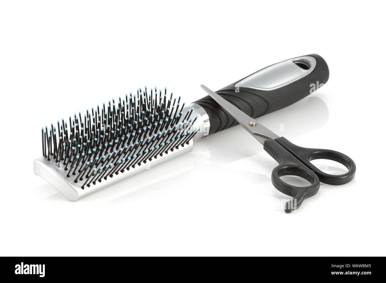 A hair brush and scissors isolated on white Stock Photo