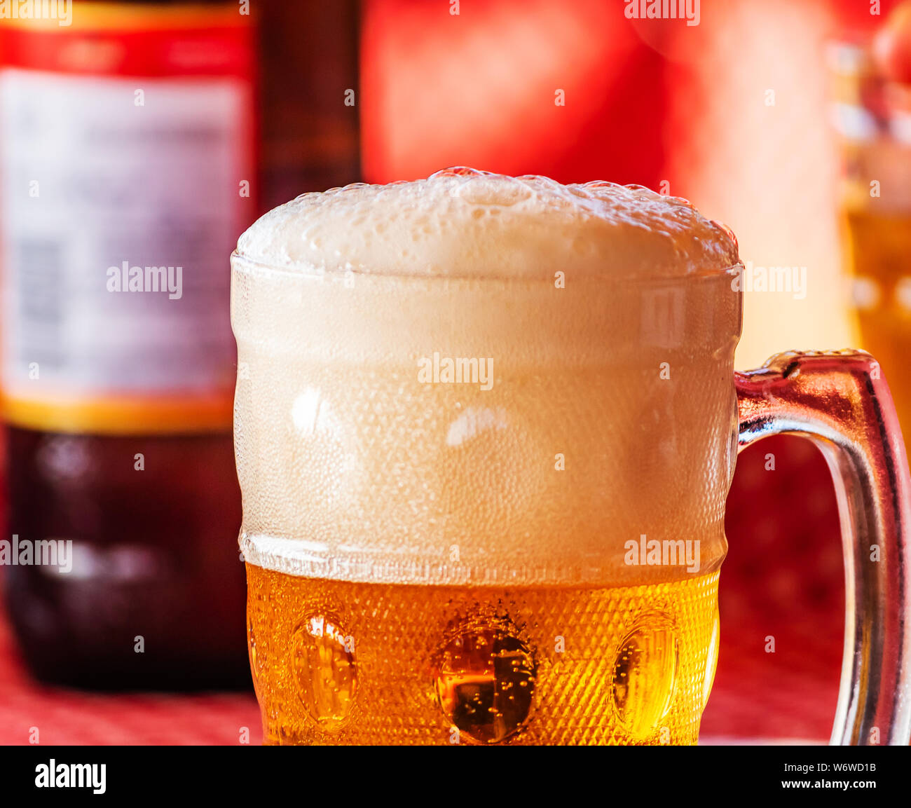 Cold beer on desk and background of summer beach with palm vagator beach Goa India Stock Photo