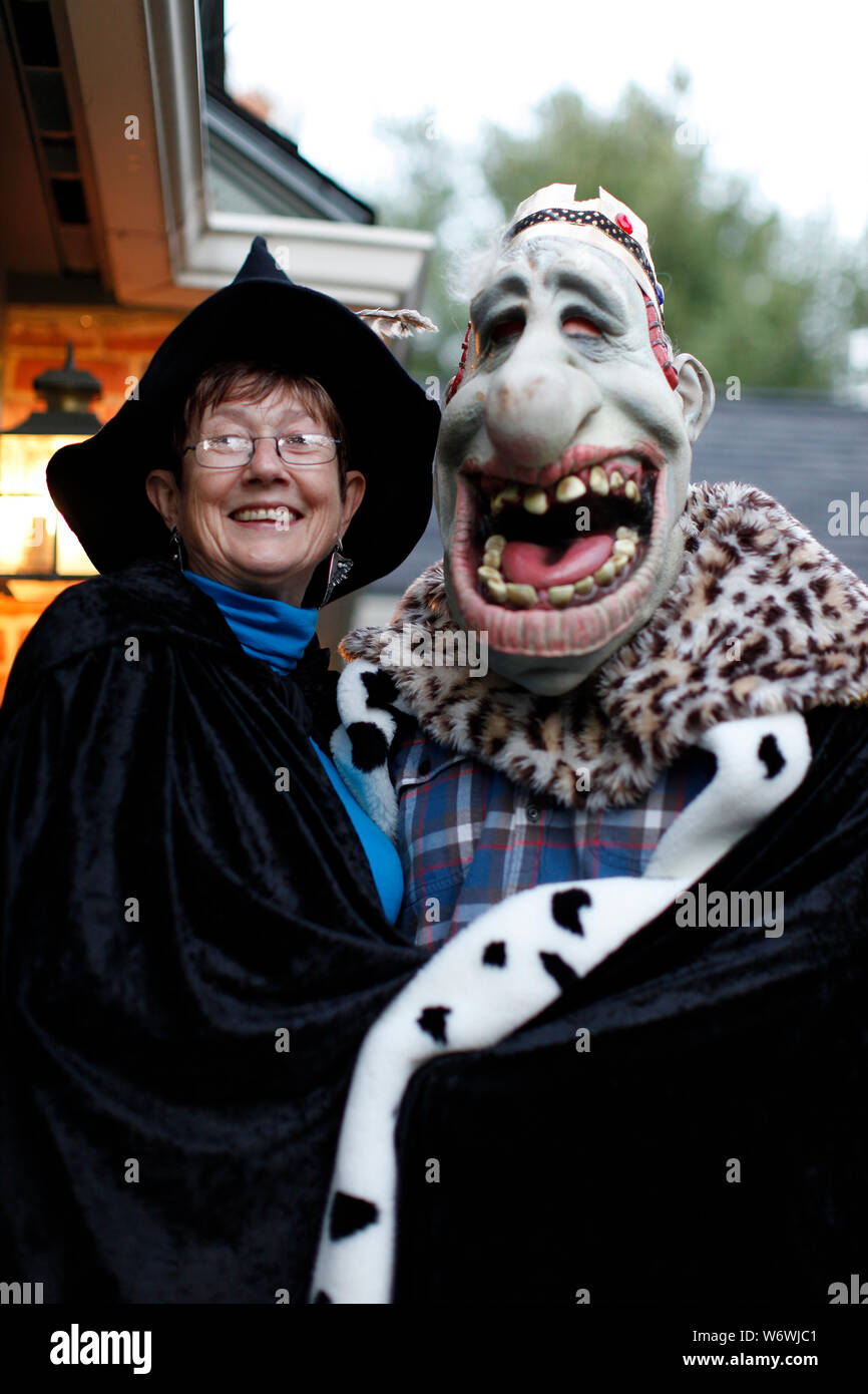 Happy Witch and Laughing Ogre play Trick or Treat Stock Photo