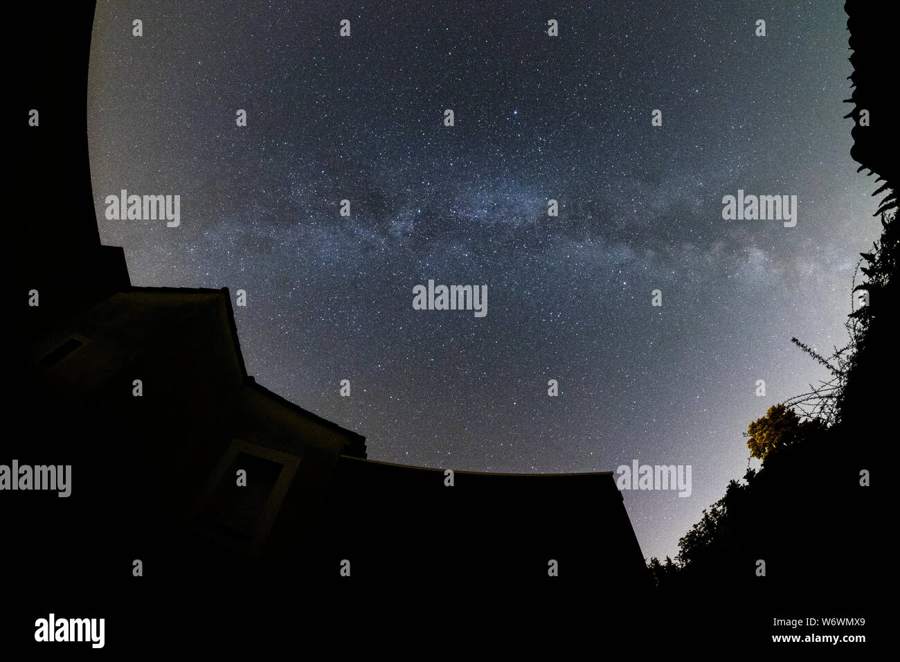 Sablet, The Vaucluse, France. 3rd August 2019. Clear dark skies in southern France show the Milky Way appearing brightly in the night sky above a village house. Credit: Malcolm Park/Alamy Live News. Stock Photo