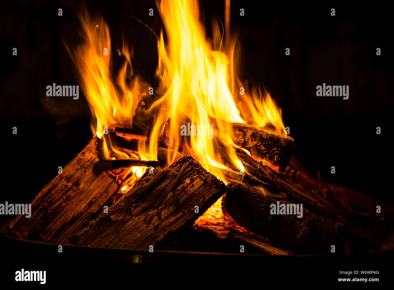 Hot burning fire flames generating heat in dark cold winter night Stock ...