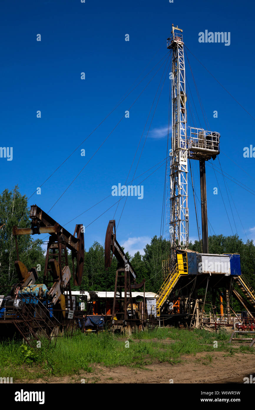 Oil and Gas Drilling Rig onshore dessert with dramatic cloudscape. Oil