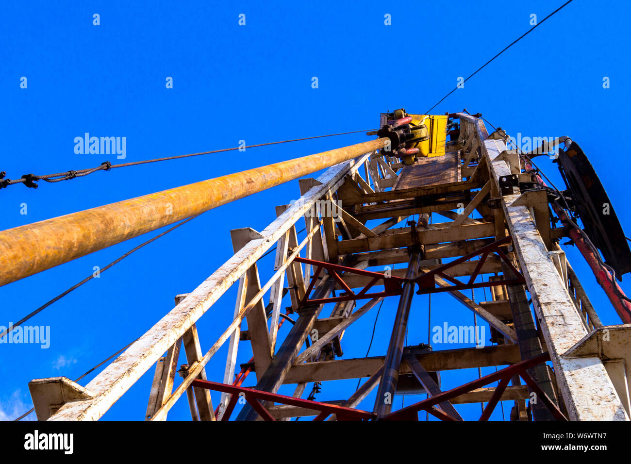 Oil and Gas Drilling Rig onshore dessert with dramatic cloudscape. Oil