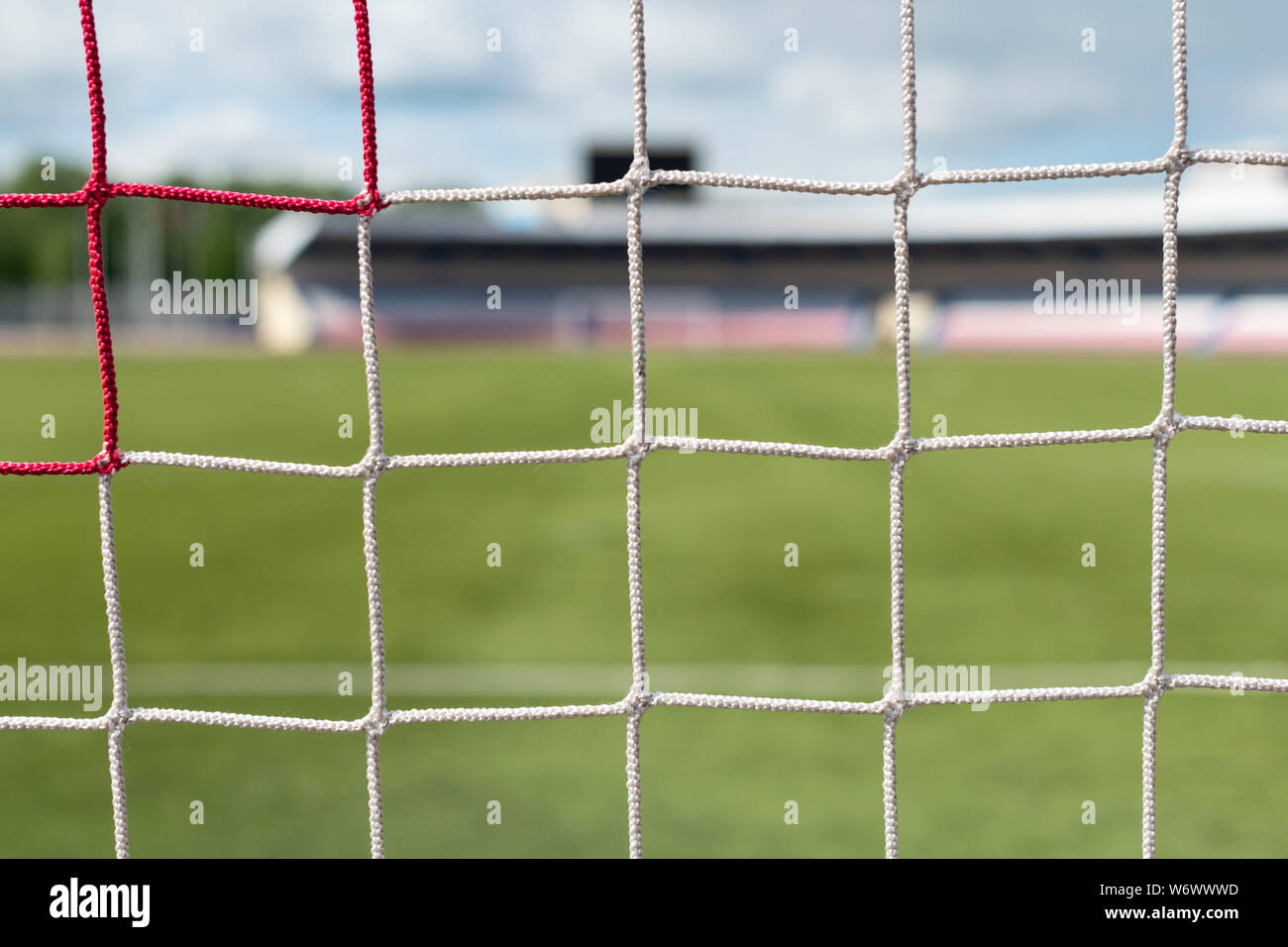 Football goals at stadium. Soccer field background. White and red nets color Stock Photo Alamy