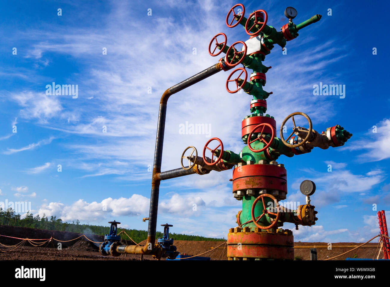 Horizontal view of a wellhead with valve armature. Oil and gas industry ...
