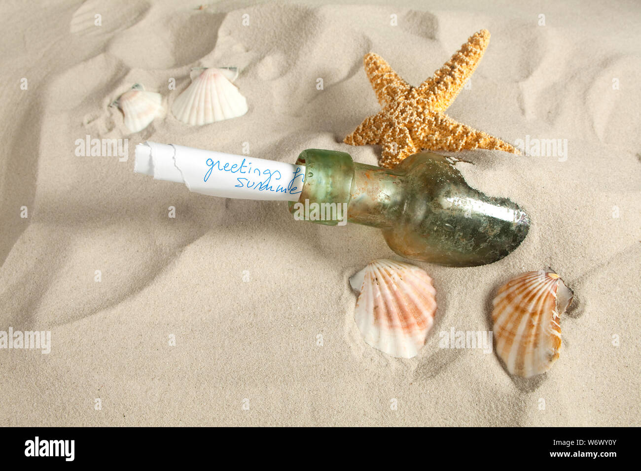 Holiday greetings sent as a message in a bottle on a beach Stock Photo