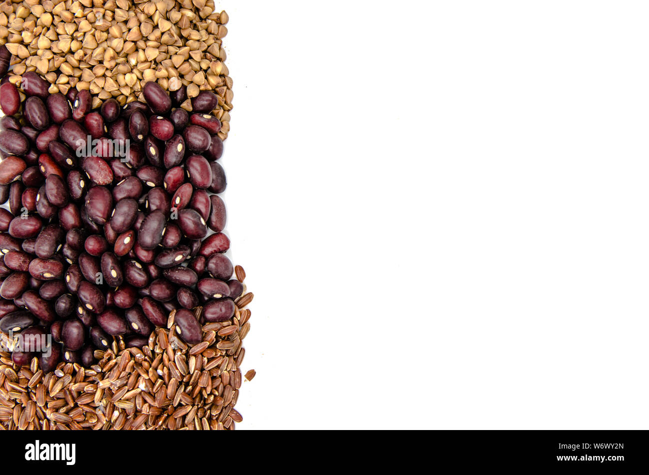 red beans, brown ruby rice and buckwheat on a white background with copy space Stock Photo