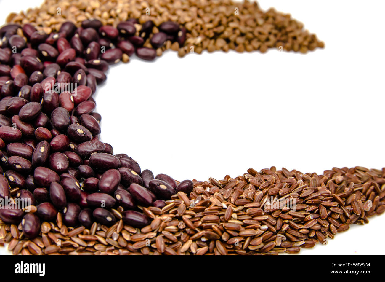 red beans, brown ruby rice and buckwheat on a white background with copy space Stock Photo