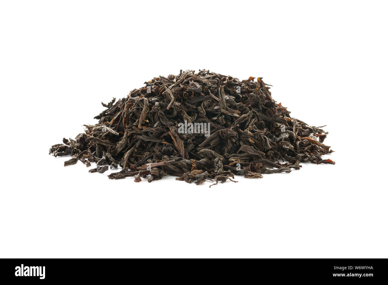Dry black tea leaves isolated on white background. Stock Photo