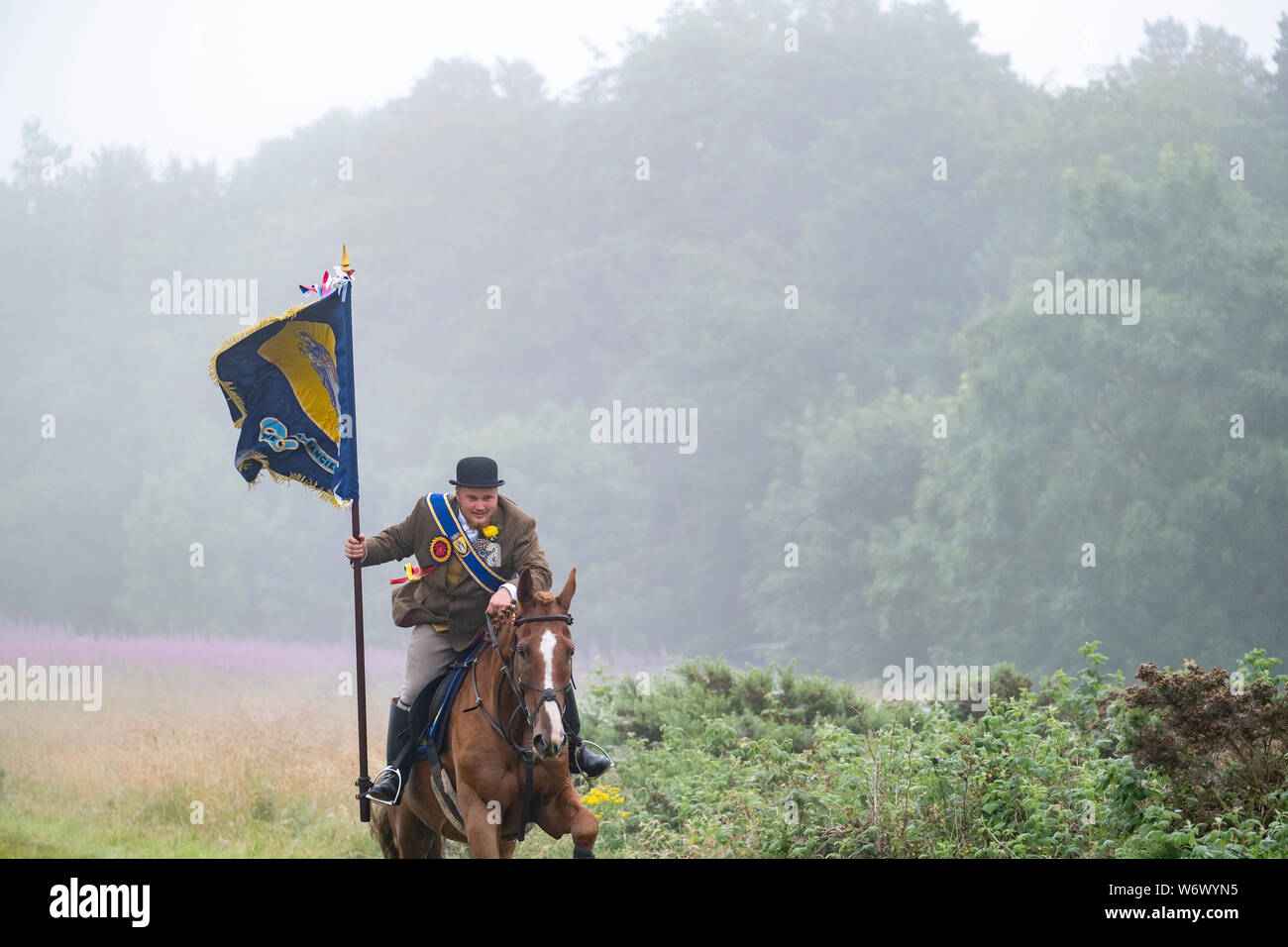 Lauder, SCOTLAND - August 03: Lauder Common Riding 2019. Christopher Purves, Lauder Cornet 2019 with the Burgh Standard galloping up the Golf Course at the start of the ride out. Lauder Common Riding is part of a tradition of Common Ridings and similar festivals in the Borders and south of Scotland. The main event is a Riding of over 300 horses around the Common land of Lauder. The main Rideout is always the first Saturday in August and is the culmination of a whole week of events. Lauder Common Riding is proud to be one of the original and oldest Border Common Ridings. Stock Photo