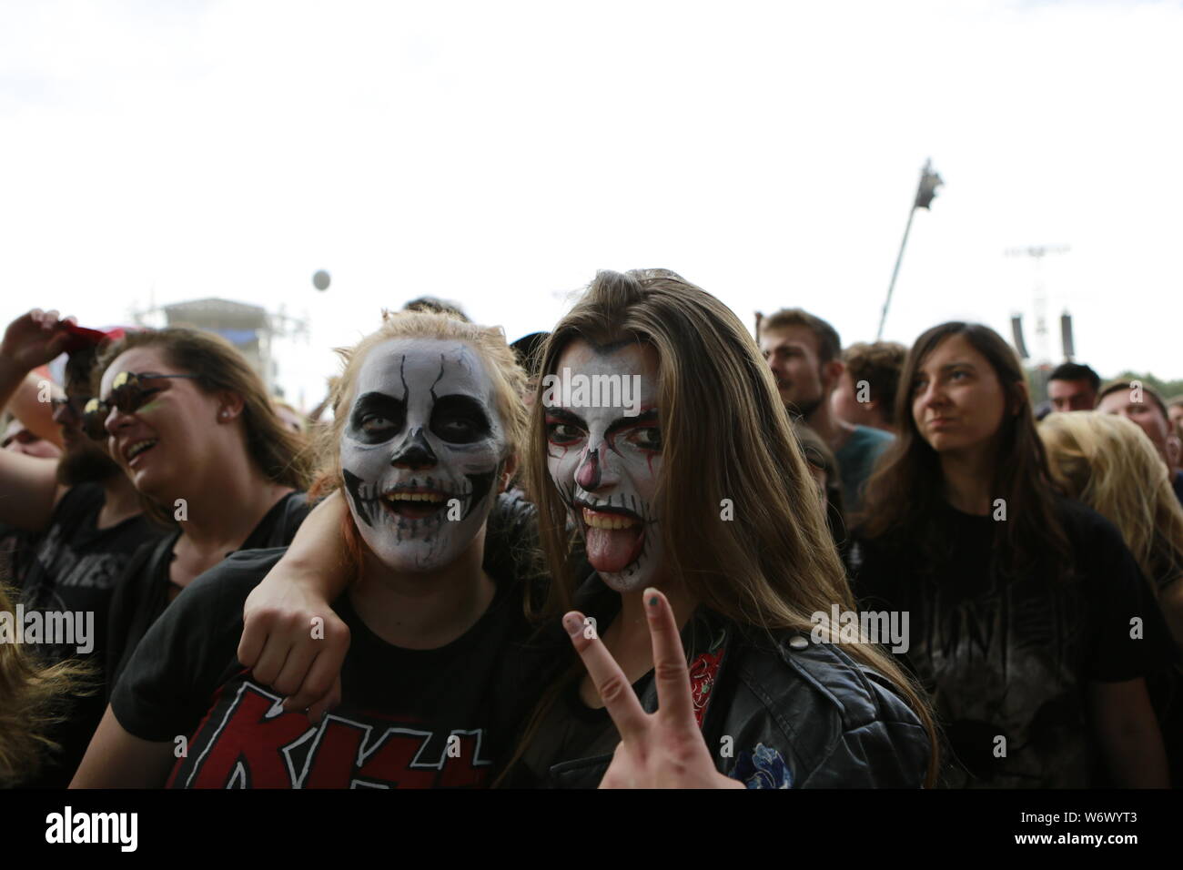 Kostrzyn, Polen, 2 August 2019, two young women with face painting in front of main stage. 25. Pol'and'Rock Festival is the biggest non-commercial festival in Europe. This year the festival will take place on 1-3 August in the town of Kostrzyn nad Odra in western Poland. Stock Photo