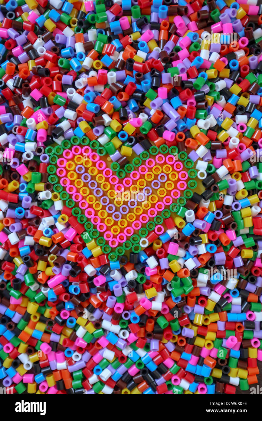 background with colorful beads, macro wallpaper and hearts made from beads  Stock Photo - Alamy