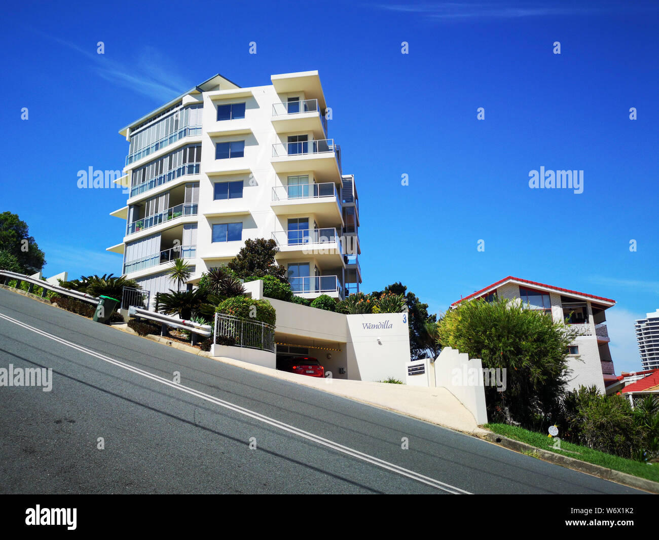 Coolangatta, Australia: March 25, 2019: Luxury apartment building with balconies and palm trees on Hill Street, the steepest road in Coolangatta. Stock Photo