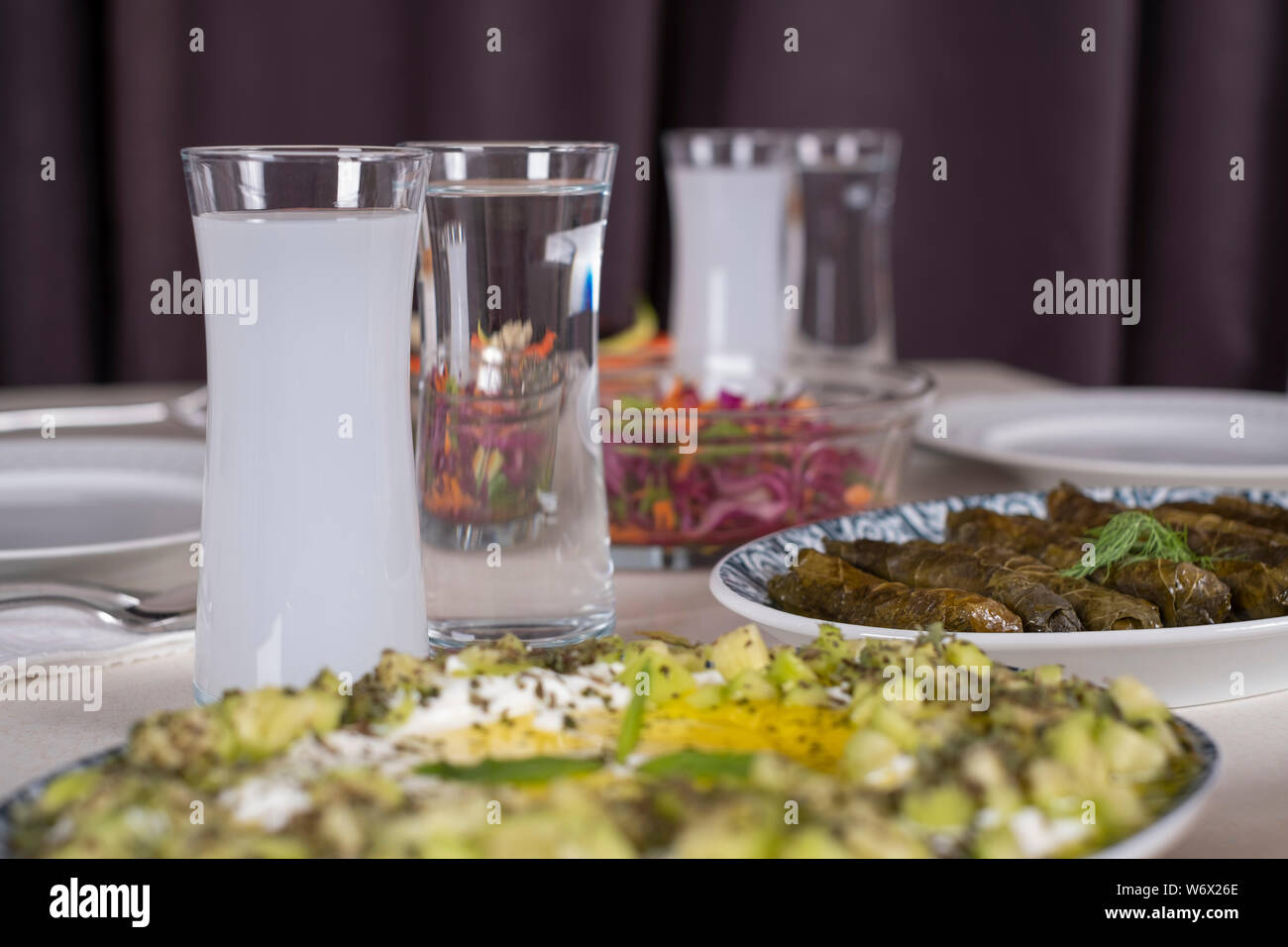 Turkish and Greek Traditional Dinning Table with Special Alcohol Drink Raki. Ouzo and Turkish Raki is a dry anise flavoured aperitif. Stock Photo