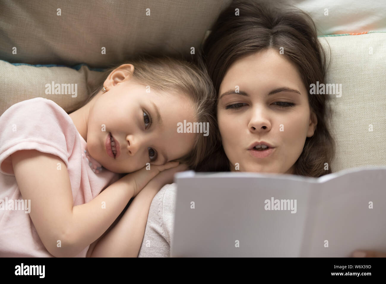 Mother reading to little daughter fairy tale before bed Stock Photo
