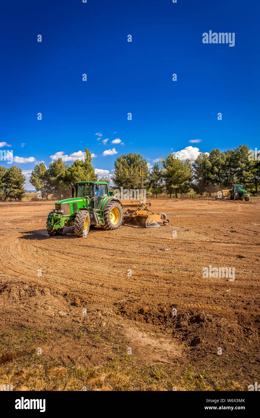 Tractors leveling in the field Stock Photo Alamy
