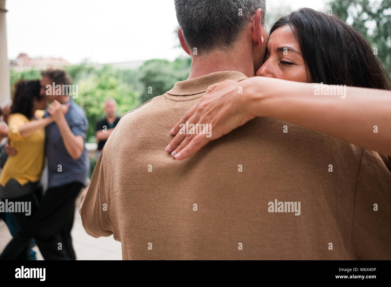 Barcelona, Spain - 10 july 2019: adult couple dancing tango with passion and huggin tight in outdoors park moving close to each other Stock Photo
