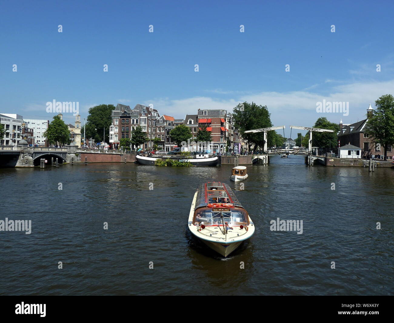 Cruise boats sailing the Amstel River near Walter Süskindbrug Stock Photo