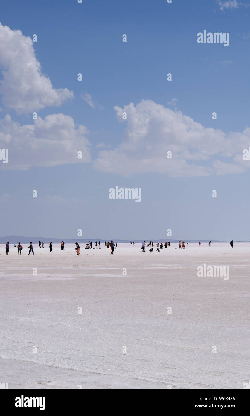 Turkey: people in the distance walking on the salt expanse of Lake Tuz, Tuz Golu, the Salt Lake, one of the largest hypersaline lakes in the world Stock Photo