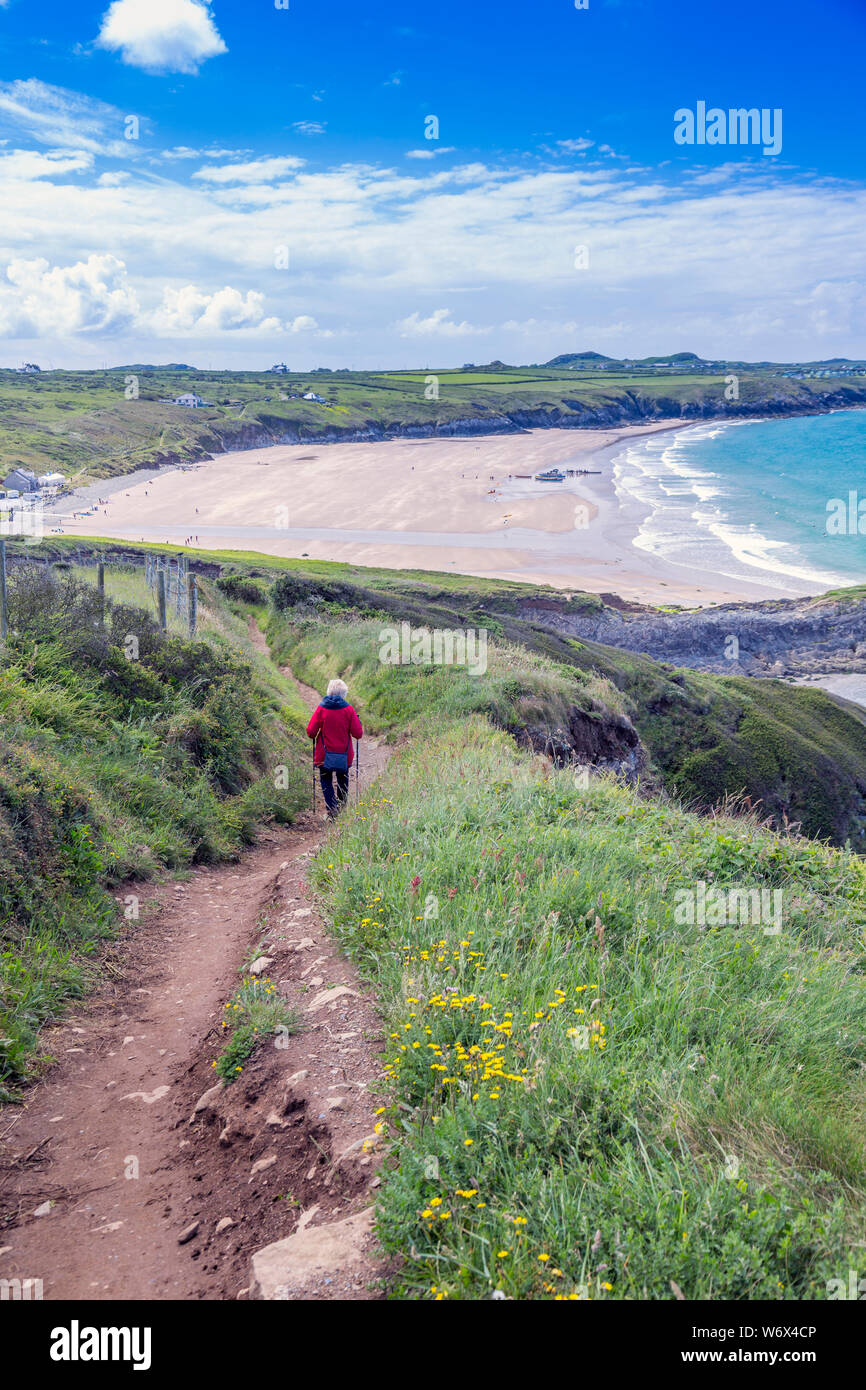 Walker on the Pembrokeshire Coast National Park coastal footpath above Whitesands Bay, Wales, UK Stock Photo