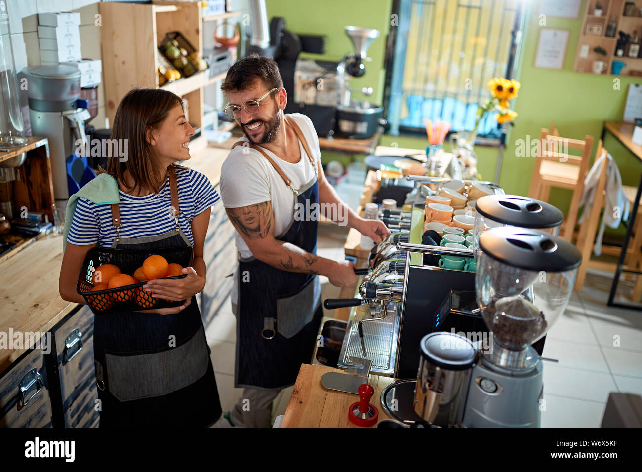 Smiling couple barista working at coffee shop Stock Photo