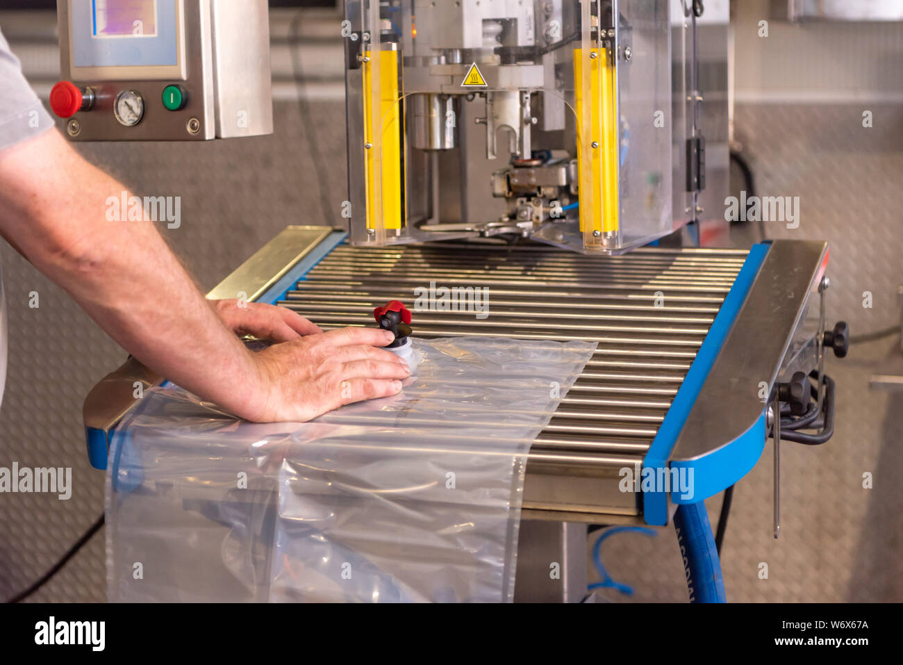 Apple direct juice after pressing. Bottling in bag in box Stock Photo