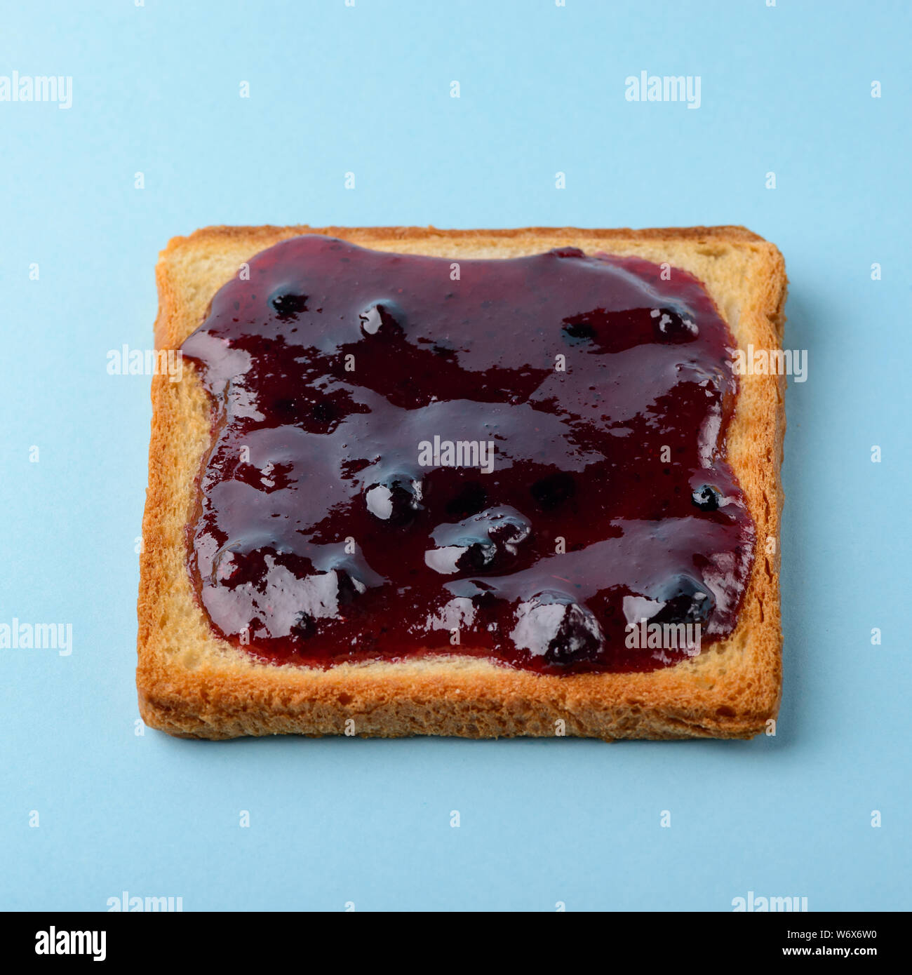 Blueberry jam toast on blue Stock Photo Alamy