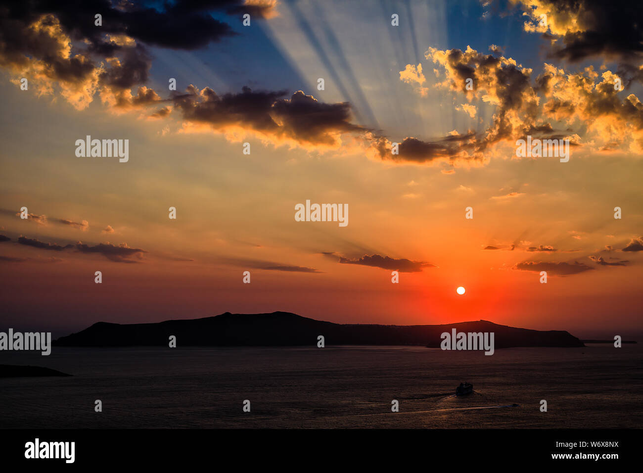 Photograph of the the sunset near the islands around Santorini in Greece Stock Photo
