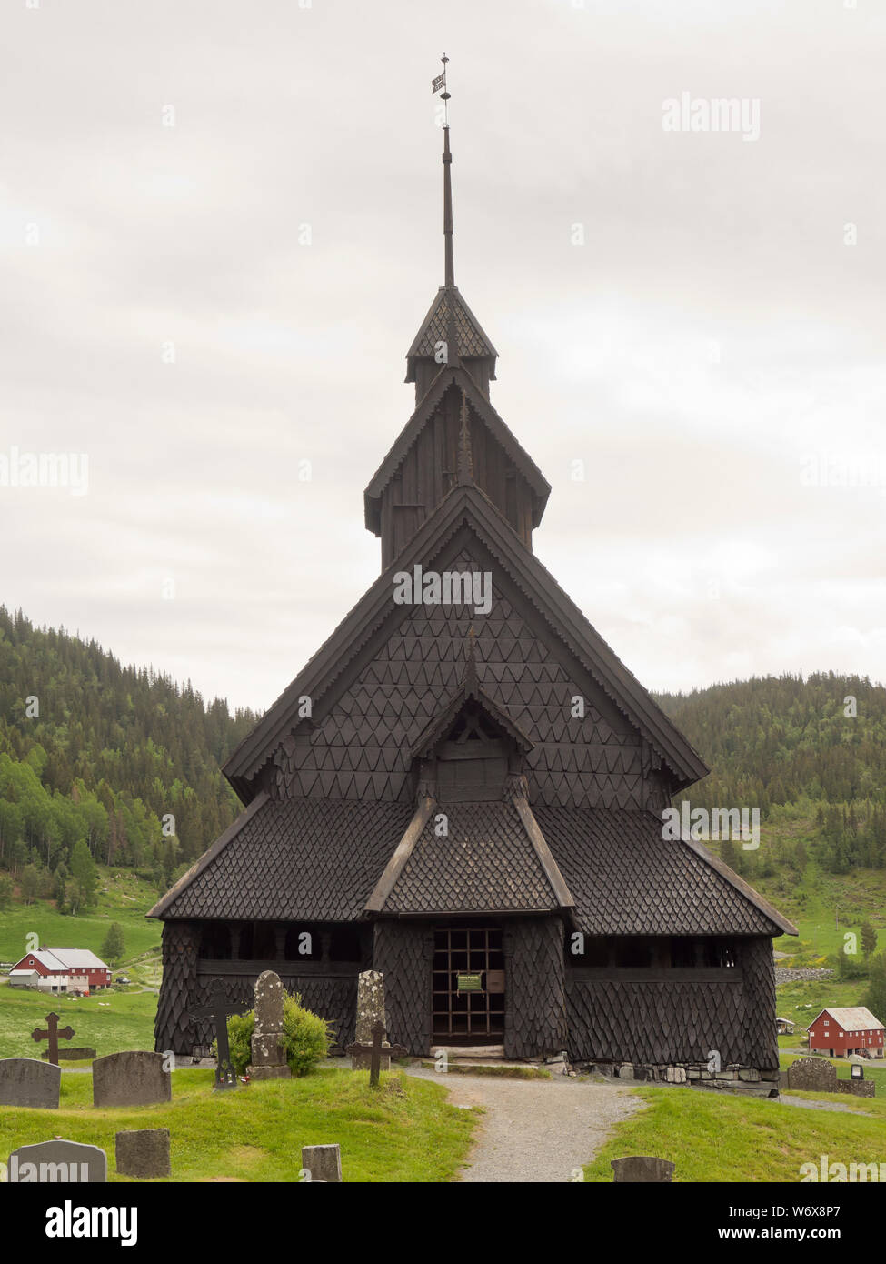 Eidsborg Stave church from the medieval period, a prime example of Norwegian wooden architecture and a tourist attraction surrounded by its cemetery Stock Photo