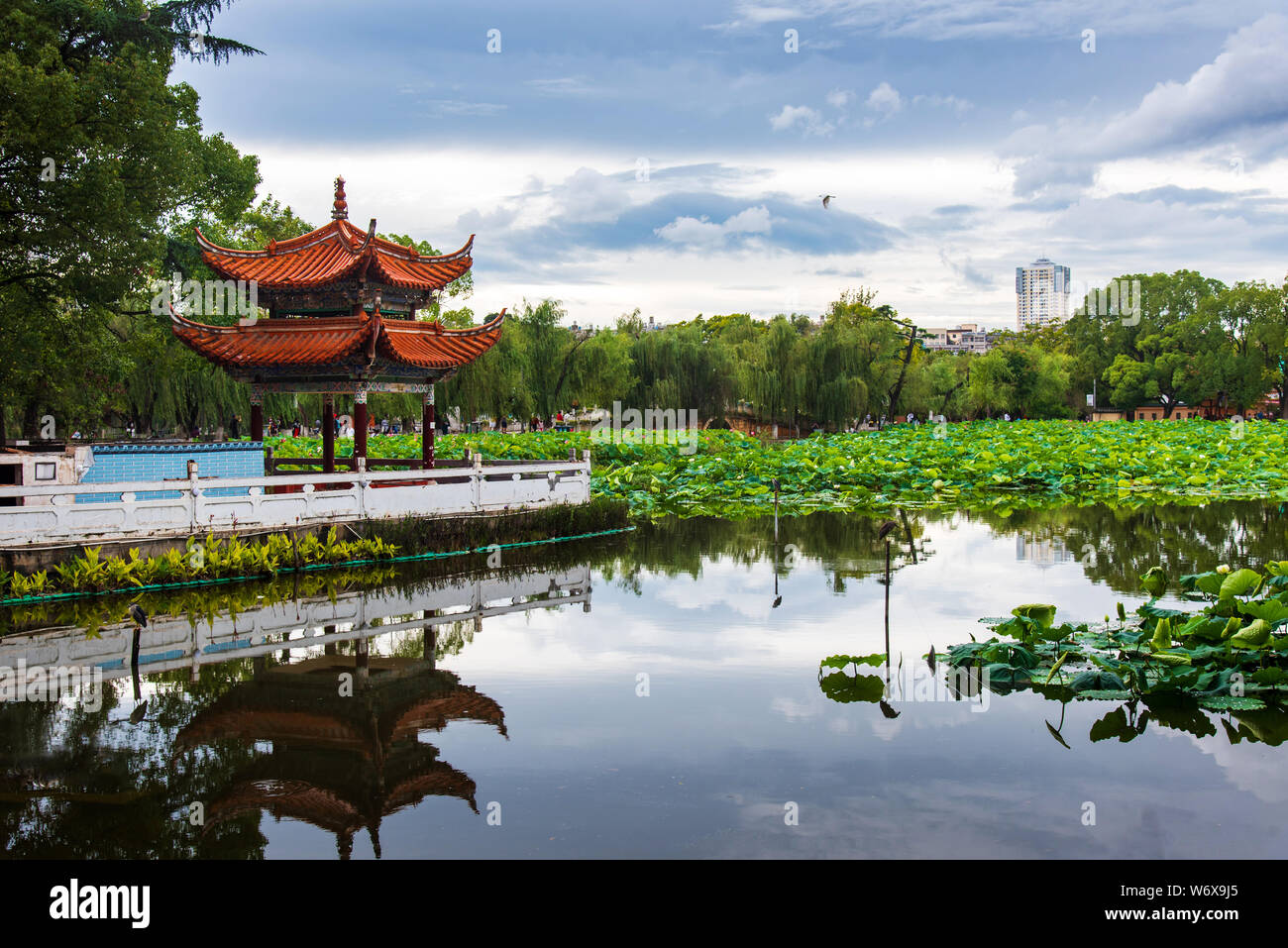 Chinese pavilion reflected in Green lake in Kunming, capital of Yunnan province of China Stock Photo