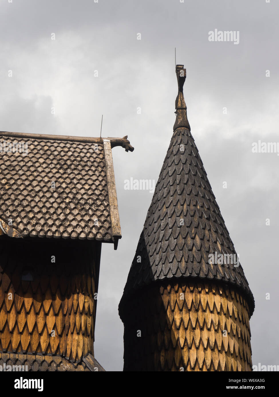 Heddal Stave church from the medieval period, a prime example of Norwegian wooden architecture and a tourist attraction, tower, carved figure, tiles Stock Photo