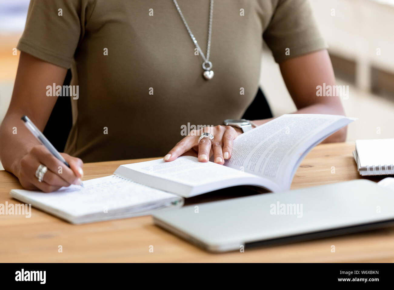 Close up african female hands holding pen make notes Stock Photo - Alamy
