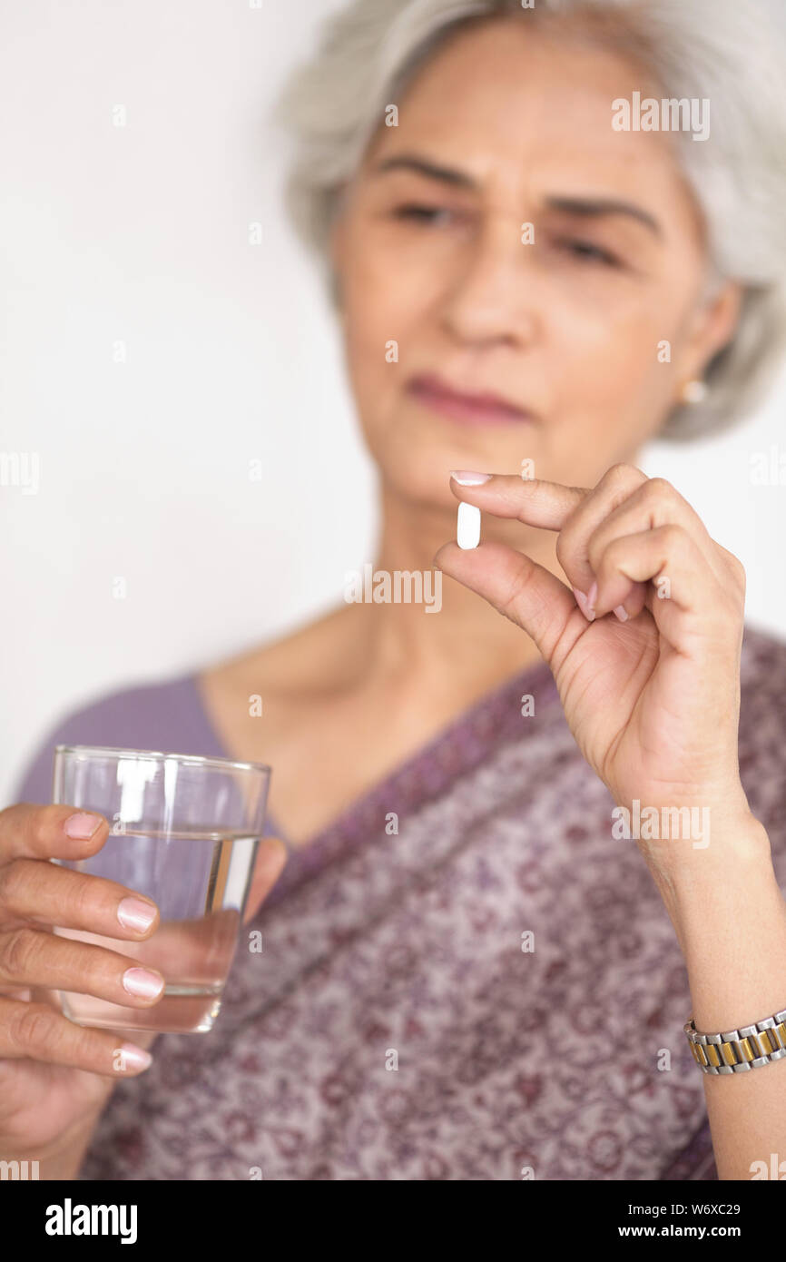 Old woman taking medicine Stock Photo Alamy