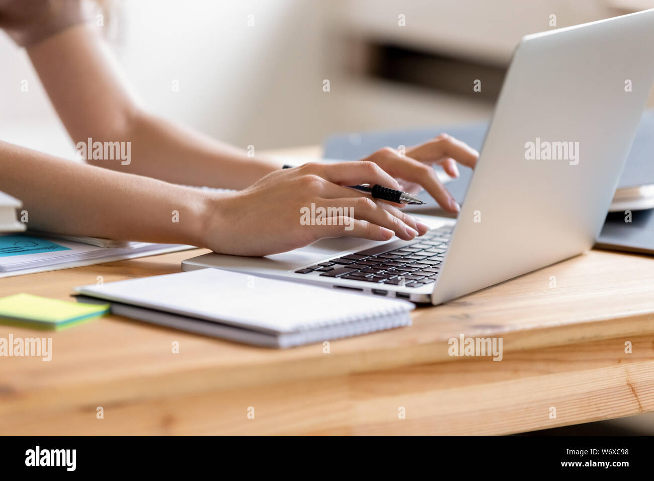 Closeup cropped image student girl hands typing using laptop Stock Photo