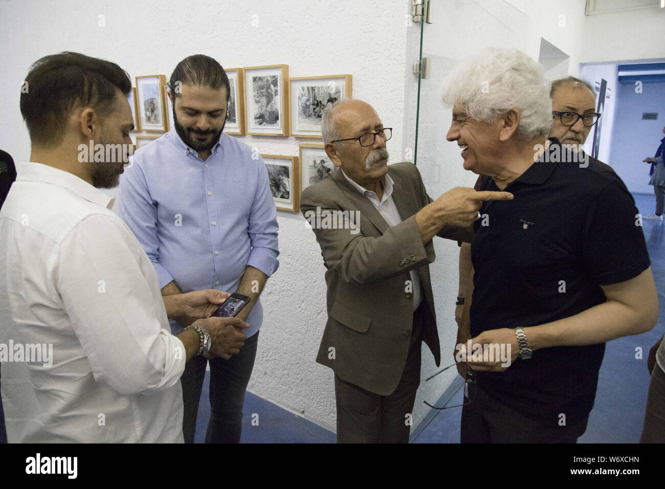 Tehran, Tehran, IRAN. 2nd Aug, 2019. People visit Iranian former AP photographer, Mohammad Sayad's exhibit at the Nabshi Gallery in Tehran, Iran. Credit: Rouzbeh Fouladi/ZUMA Wire/Alamy Live News Stock Photo