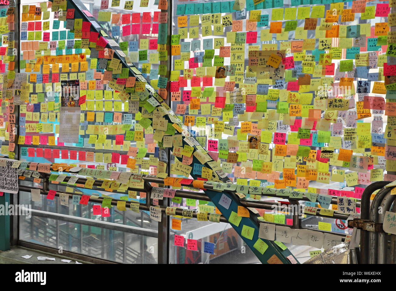 CAUSEWAY BAY, HONG KONG - JULY 17, 2019: Lennon Wall with Post It notes stuck on the glass of the Hennessey Road pedestrian overpass, showing support Stock Photo