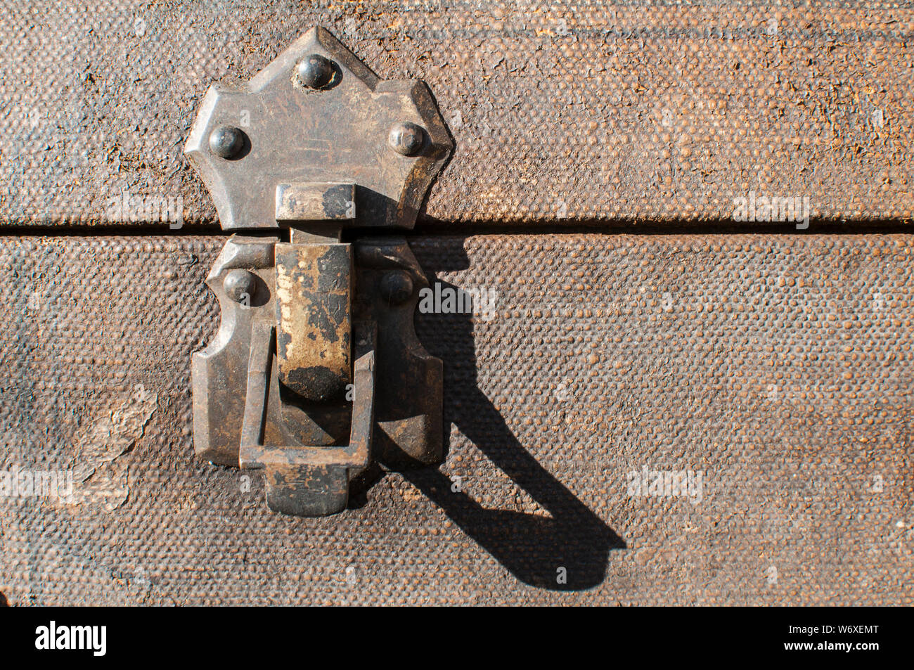 Old weathered retro vintage grunge suitcase metal latch lock closeup Stock Photo