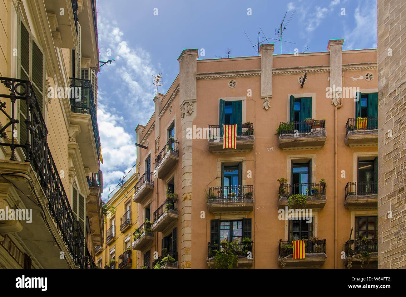 Flags of Catalonia on the balconies of a house in Barcelona Stock Photo