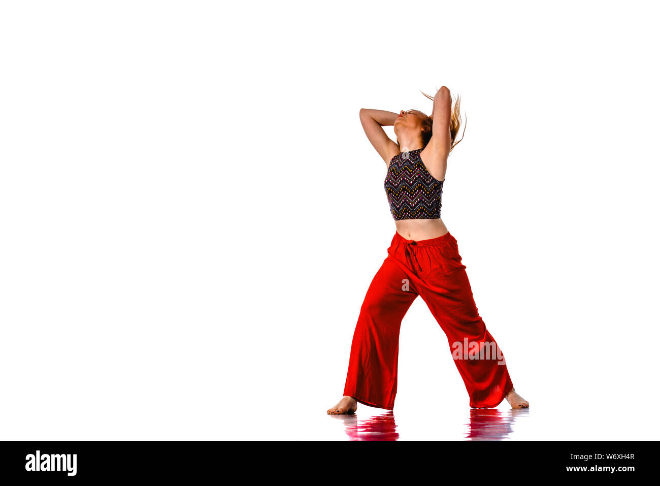 An urban woman is doing breakdance in the studio Stock Photo