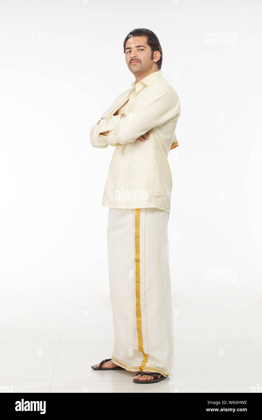 South Indian man standing with his arms crossed Stock Photo - Alamy
